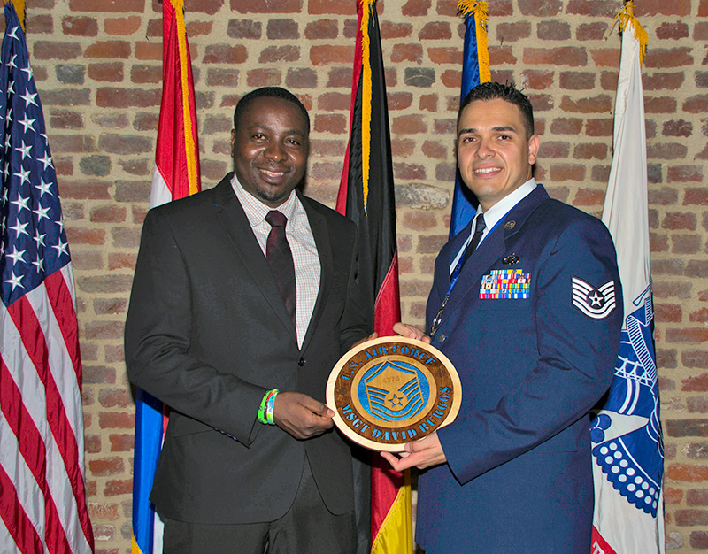 James Niba (left) presents MSgt David Burgos with his promotion plaque during the 2016 SNCO Induction Ceremony.