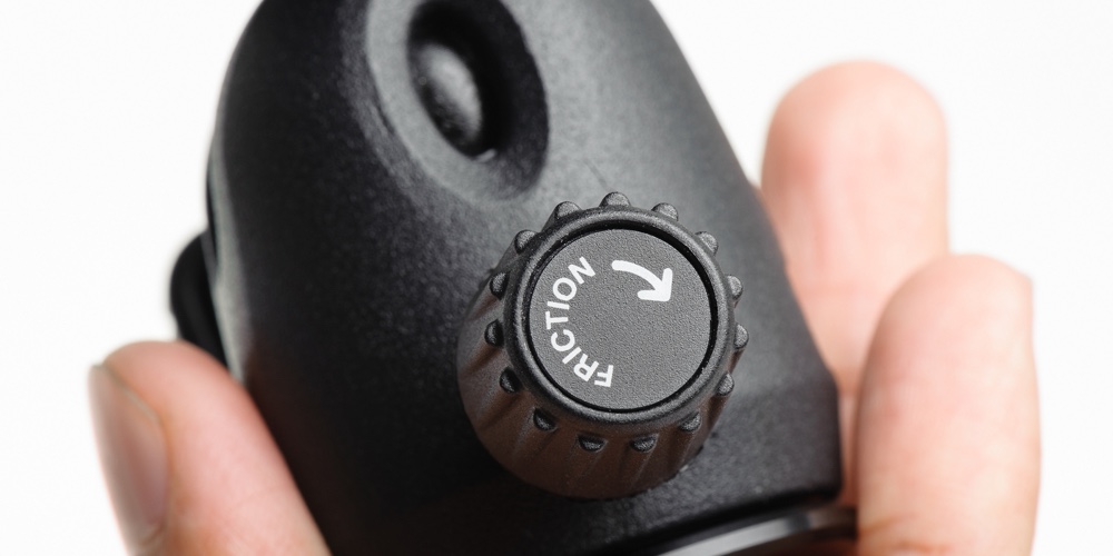 Closeup friction control knob on ball head of tripod