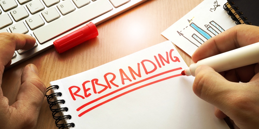 Rebranding written in a note. Rebrand marketing concept.