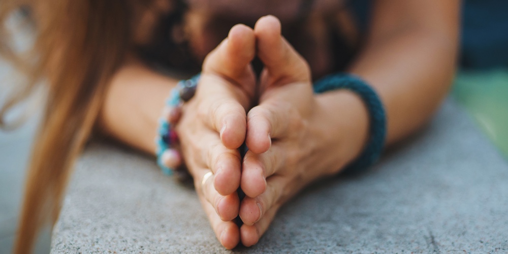 Woman hands together symbolizing prayer and gratitude. Mudra. Yoga concept.