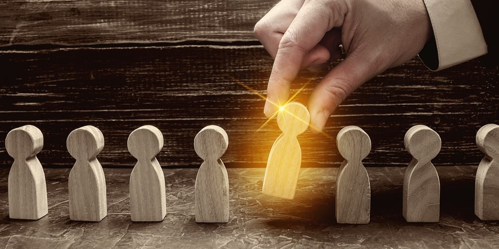 A Businessman Pulls A Glowing Golden Man Figure Out Of A Gray Crowd. The Concept Of Search Workers F