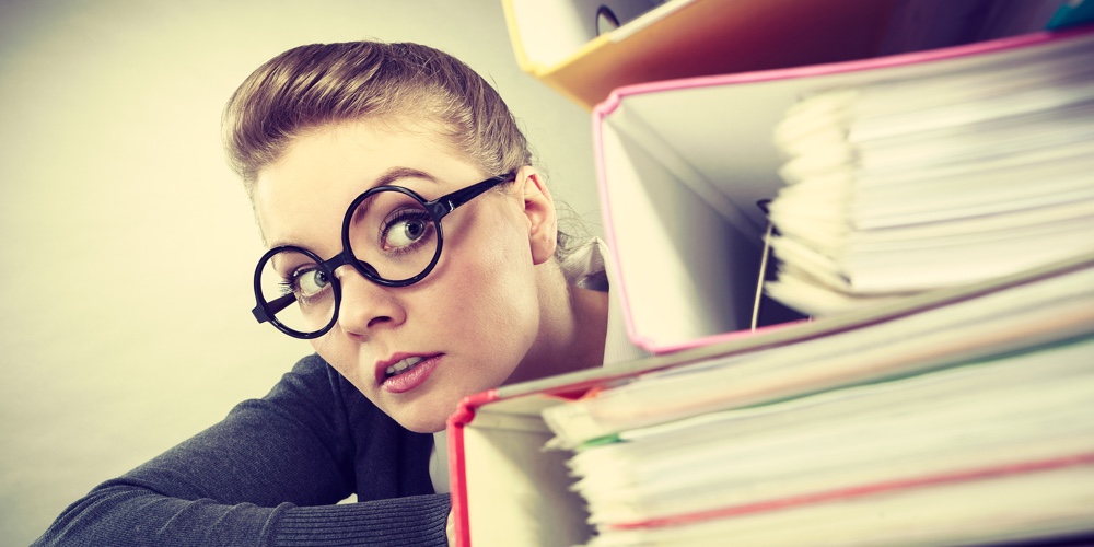 A Lot Of Work And Overwork Concept. Terrified Young Businesswoman Secretary With Huge Stack Of Binde