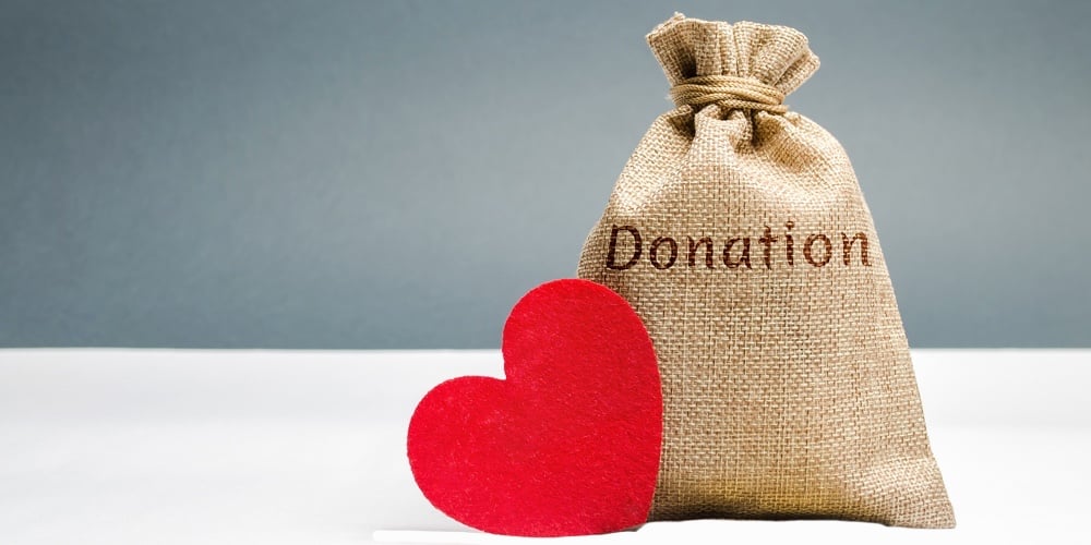 A Money Bag With The Word Donation And A Red Heart. Accumulation Of Money For A Medical Donation. He