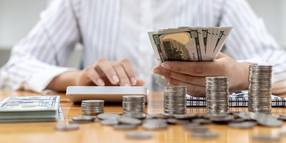 A Woman Counting Her Salary To Separate Expenses