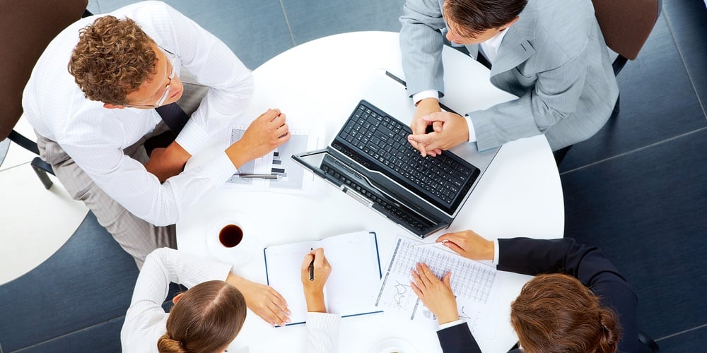 Above view of several business people planning work at round table