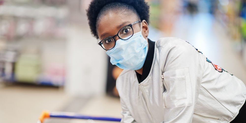 African Woman Wearing Disposable Medical Mask And Gloves Shoppin