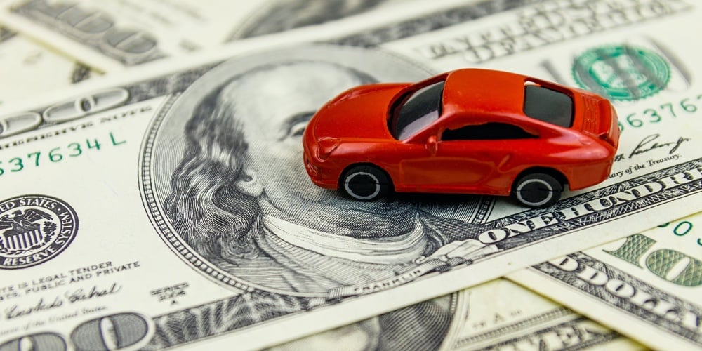 American Dollars And Miniature Car Model On White Wooden Background. Car Loan Concept