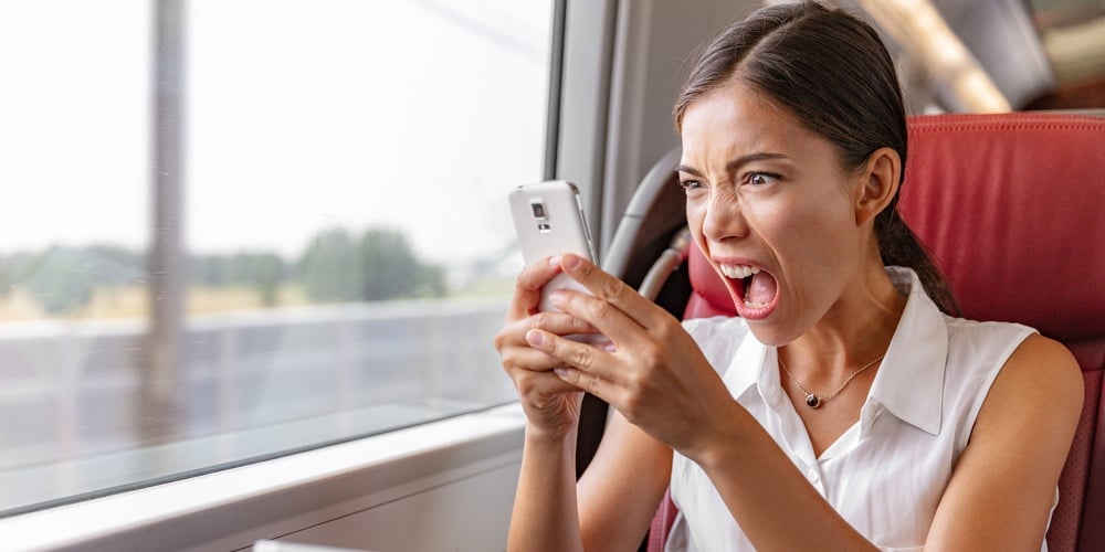 Angry Asian business woman upset screaming at phone call for communication problem or wifi internet|karen