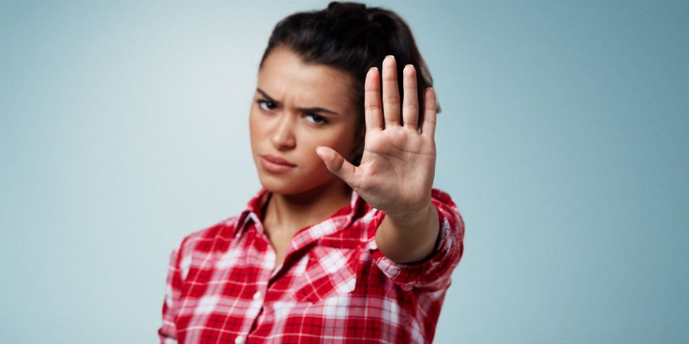 bigstock-Angry-Woman-Gesturing-Stop-Sig-105091658
