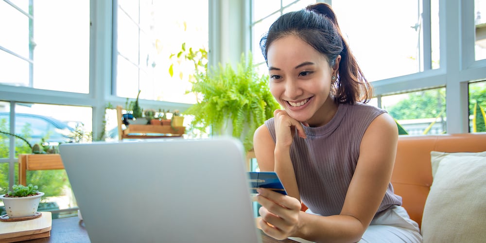 bigstock-Asian-Woman-Is-Holding-Credit-443144261
