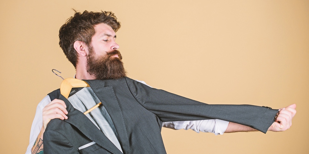 At Tailor House. Master Tailor. Bearded Man Measuring Sleeve Length Of Suit Jacket In Tailor Shop. H