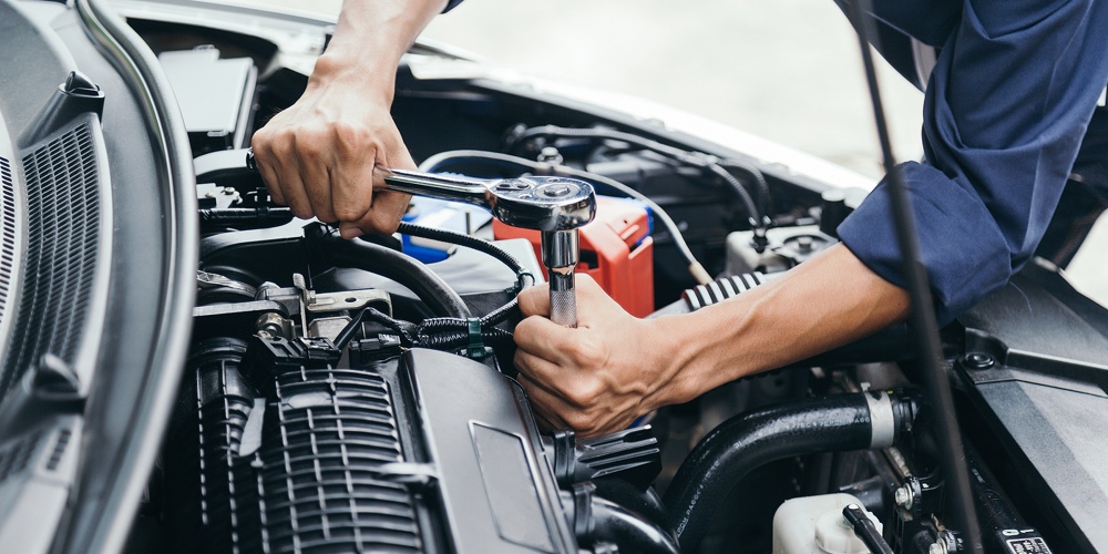 Automobile Mechanic Repairman Hands Repairing A Car Engine Automotive Workshop With A Wrench