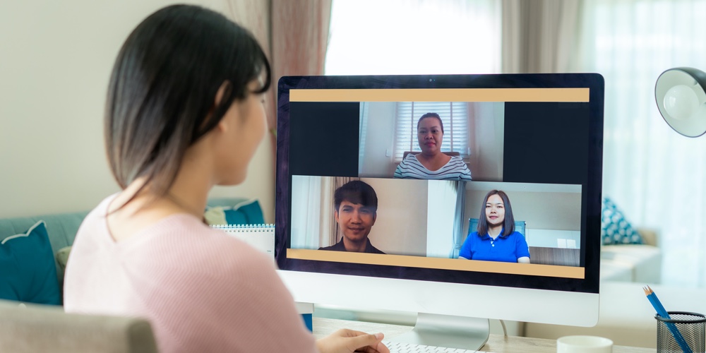Back View Of Asian Business Woman Talking To Her Colleagues About Plan In Video Conference. Multieth