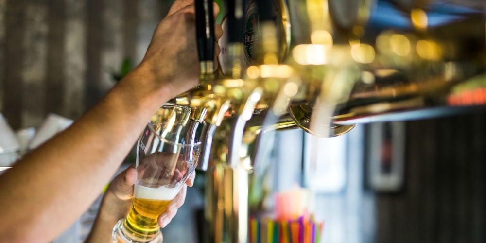 bigstock-Barman-Hand-At-Beer-Tap-Pourin-180746641