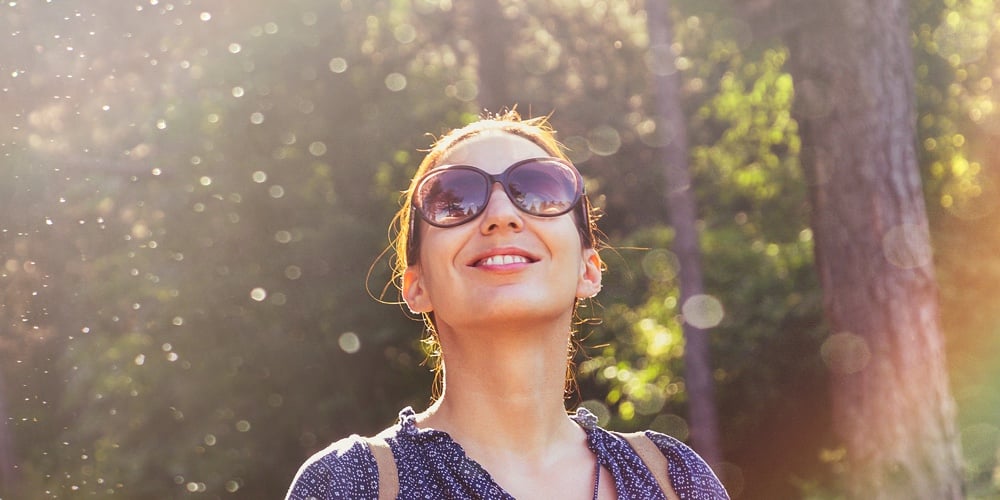 Beautiful Woman Smiling In Nature. Happy People Lifestyle. Woman Smiling In Sunshine With Water Drop