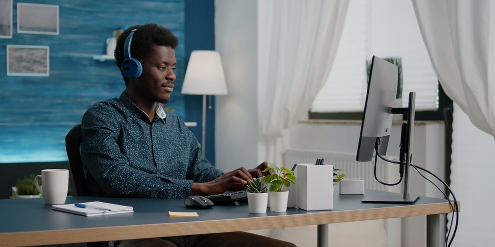 bigstock-Black-Man-Using-Headphones-To-423735788