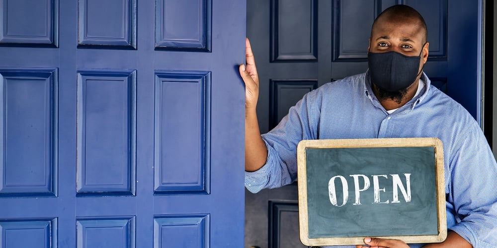Black business owner in mask during new normal post pandemic
