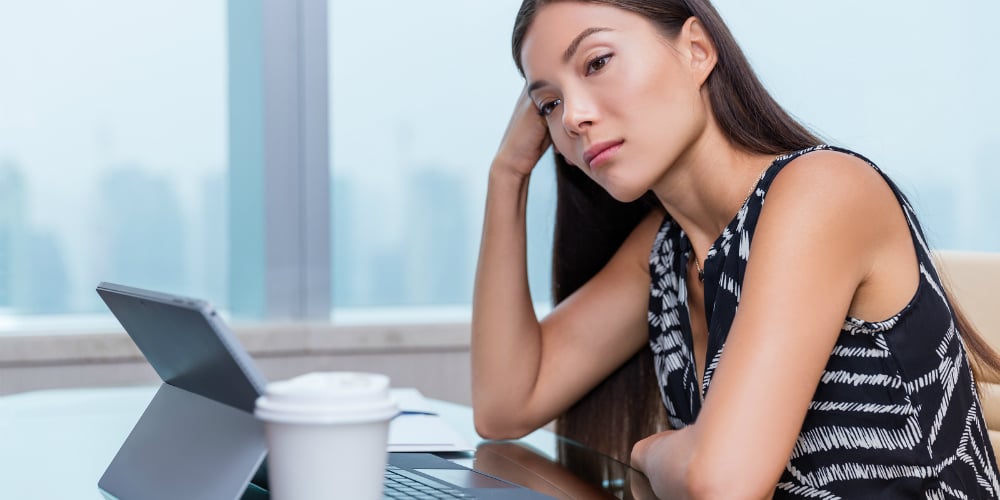 bigstock-Bored-or-sad-woman-working-at-150075884