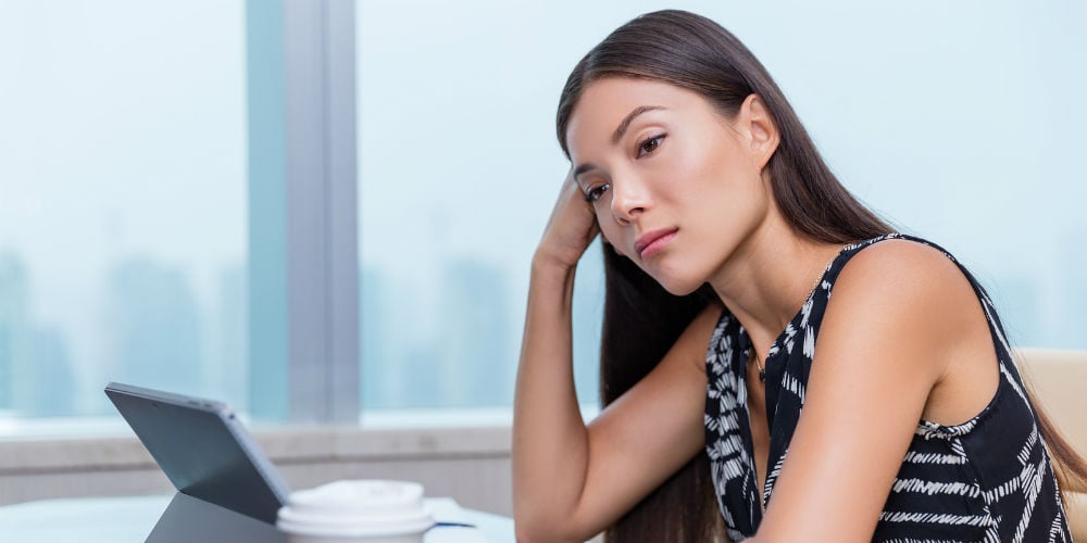 bigstock-Bored-or-sad-woman-working-at-150075884