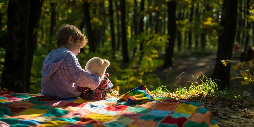 Boy Cute Child Play With Teddy Bear Toy Forest Background. Child Took Favorite Toy To Nature. Picnic