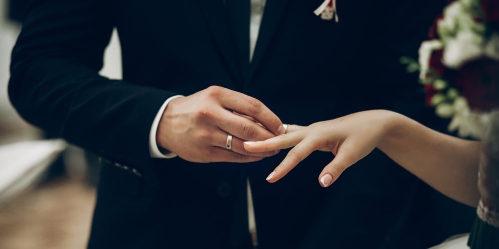 bigstock-Bride-And-Groom-Exchanging-Wed-190114462