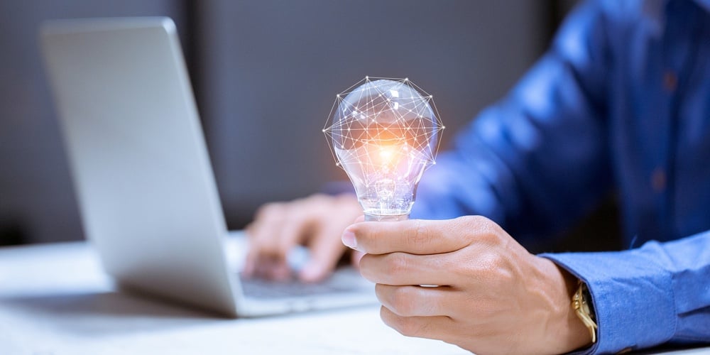 bigstock-Business-Hand-Holding-Light-Bu-344371030