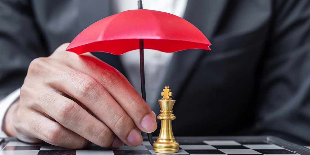 Business Man Hand Holding Red Umbrella Cover Chess King Figure. Business