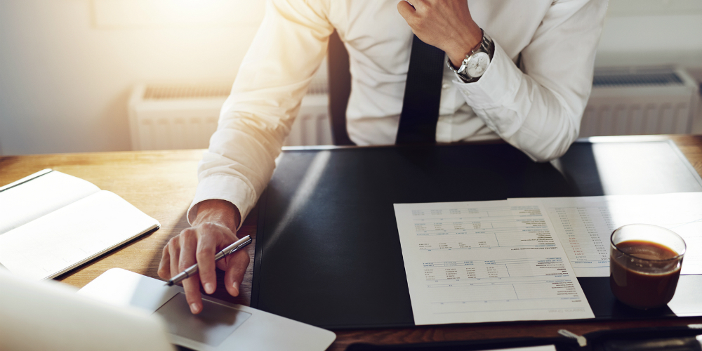 bigstock-Business-Man-Working-At-Office-106691141