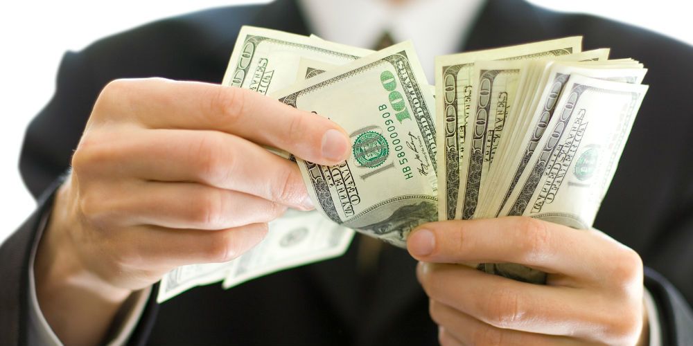 bigstock-Business-Money-In-Hands-3204538