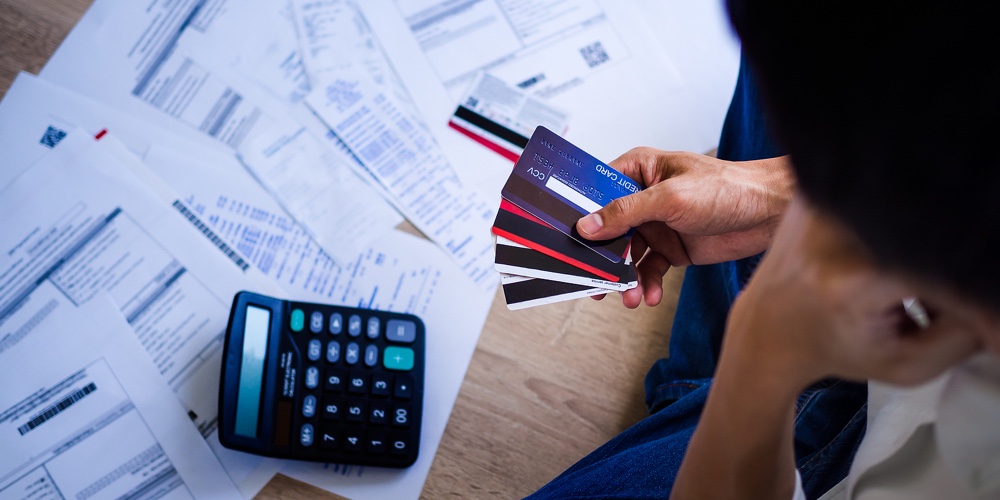 Business People Are Stressed About Credit Card Debt And Many Bills On The Floor. Men Get Trouble By