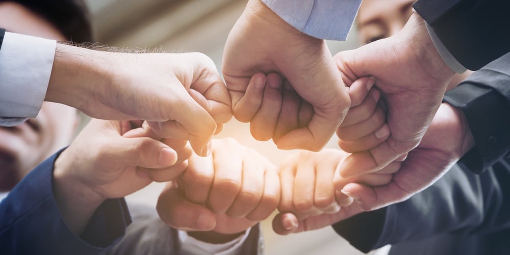 bigstock-Business-People-Joining-Hands-181864057