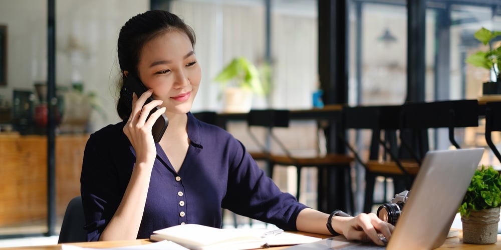 Business Woman Hand Holding Pen And Cell Phone With Bank Savings Account Application