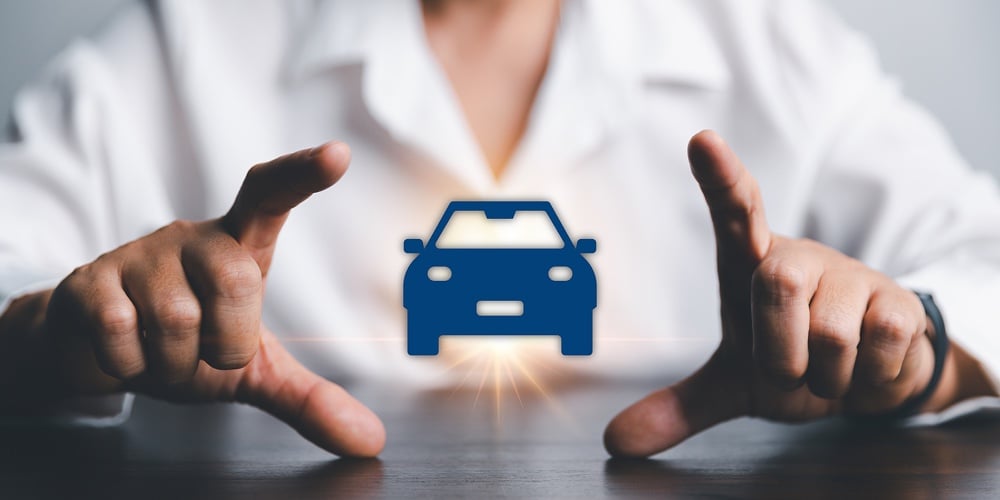 2023_Summer_League_Newsletter_-_Payment_Protection_article_image_-_HR|Business Woman’s Hand Protecting Blue Icon Car On Desk. Planning To Manage Transportation Finance Co