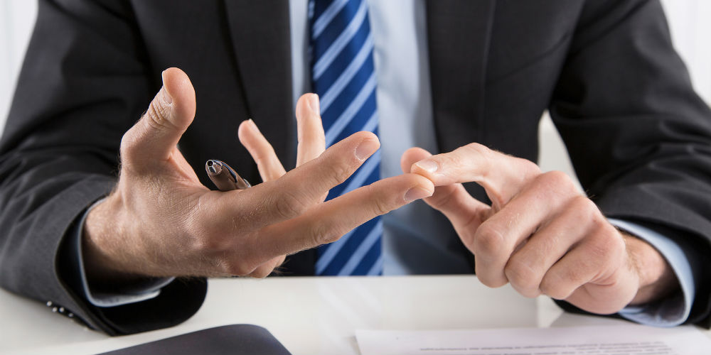 bigstock-Business-man-talking-with-hand-73694629