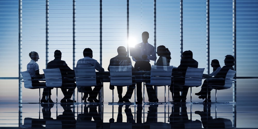 bigstock-Business-people-in-a-board-roo-209994802