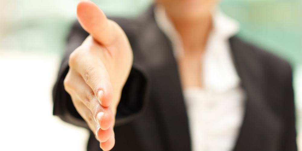 bigstock-Business-woman-gives-a-handsha-25047932