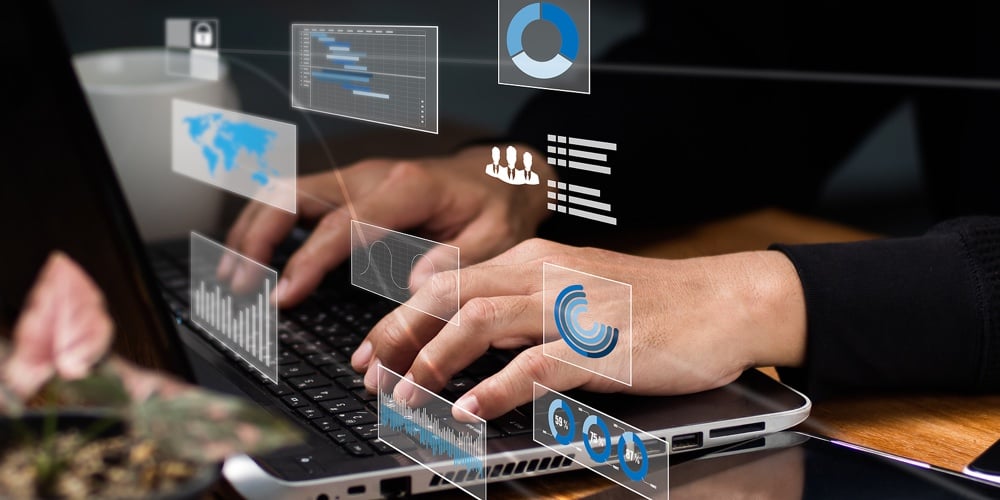 Businessman Enjoys A Cup Of Coffee While A Programmer Examines And Produces Data On A Future Virtual