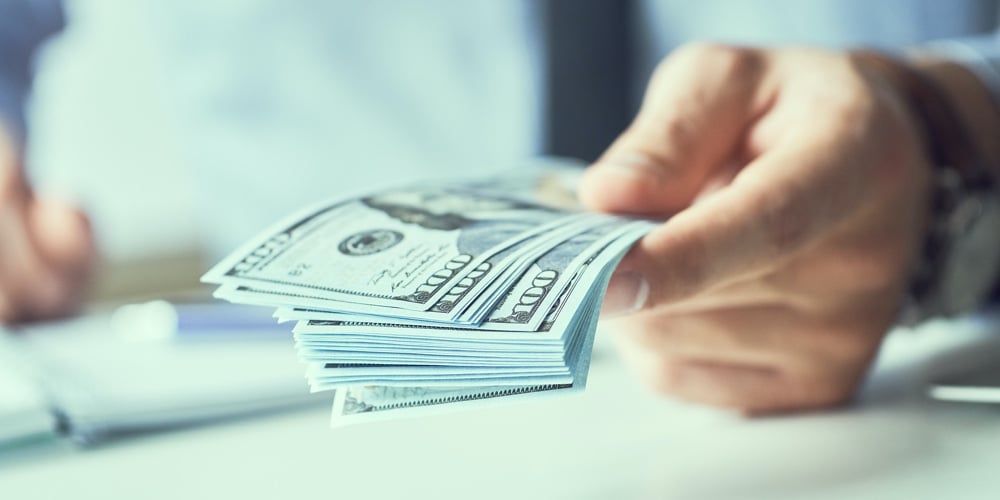 Businessman Giving Money Us Dollar Banknotes And Holding Cash In Hands. Money Credit Concept. Toned