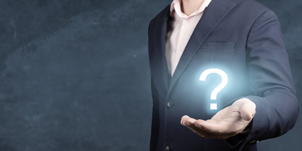 Businessman Holding Hand Question Marks In His Hand. Businessman Showing Question Mark. Man Holds A
