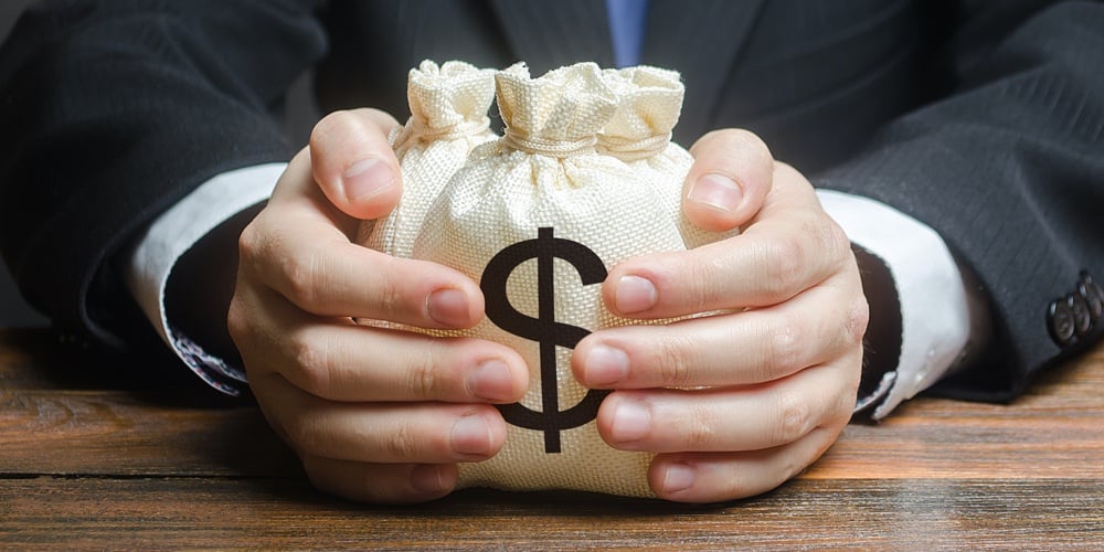 bigstock-Businessman-Hugs-Us-Dollar-Mon-348914233