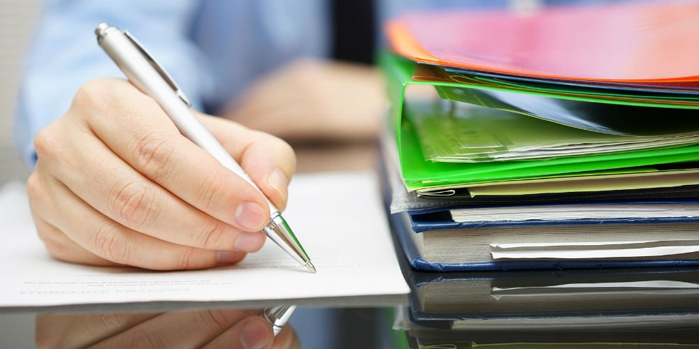 bigstock-Businessman-Is-Writing-On-Docu-81433250