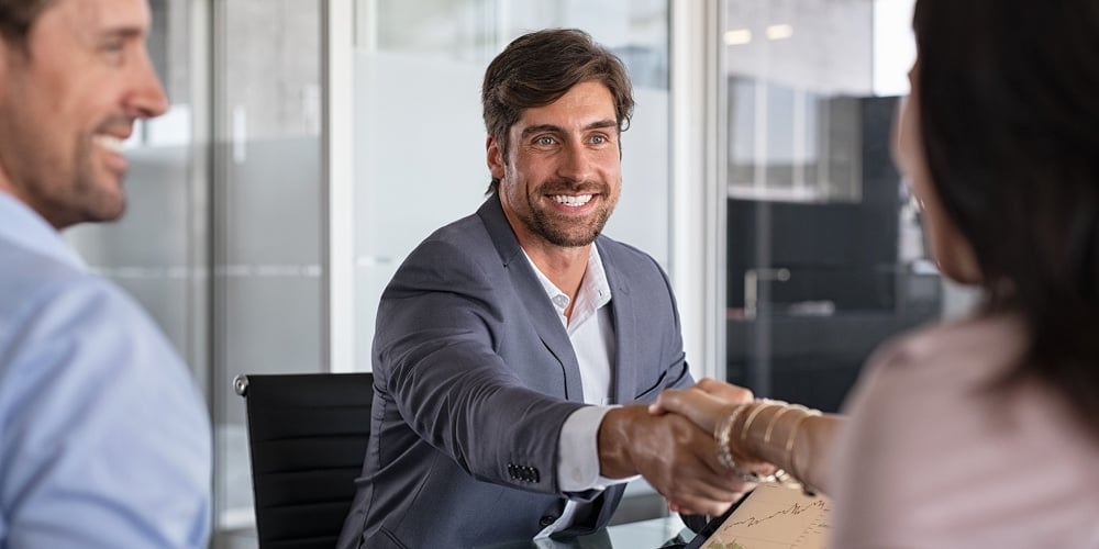 bigstock-Businessman-handshake-during-m-354384851