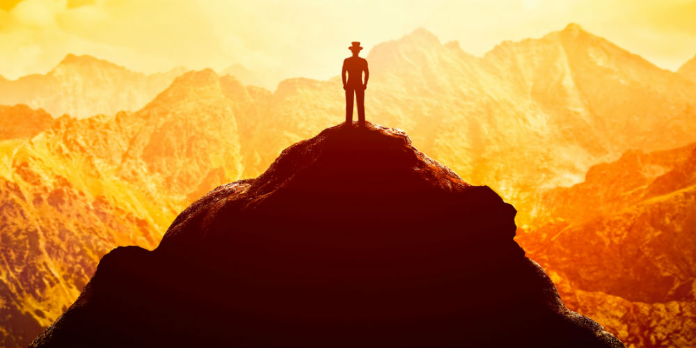 bigstock-Businessman-in-hat-on-the-peak-119932475