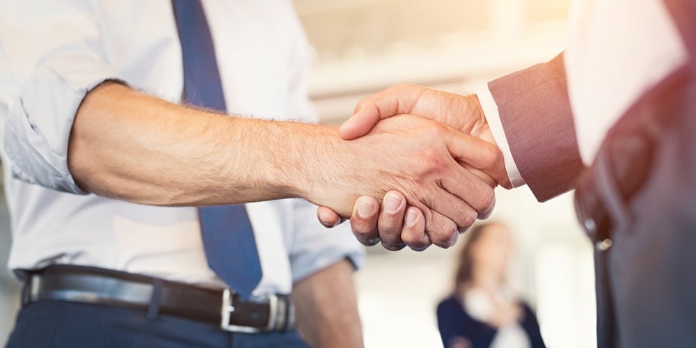 bigstock-Businessmen-shaking-hands-duri-209987992