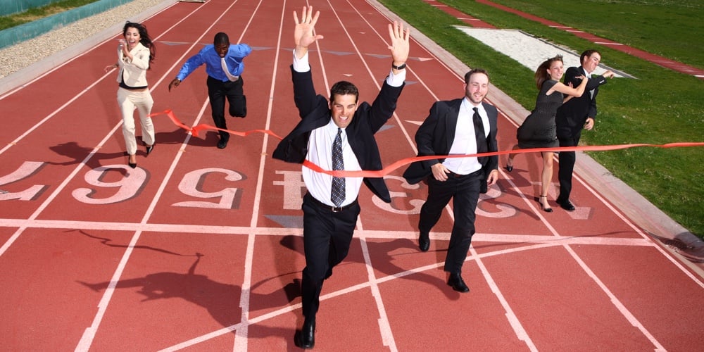 Businesspeople crossing the finish line