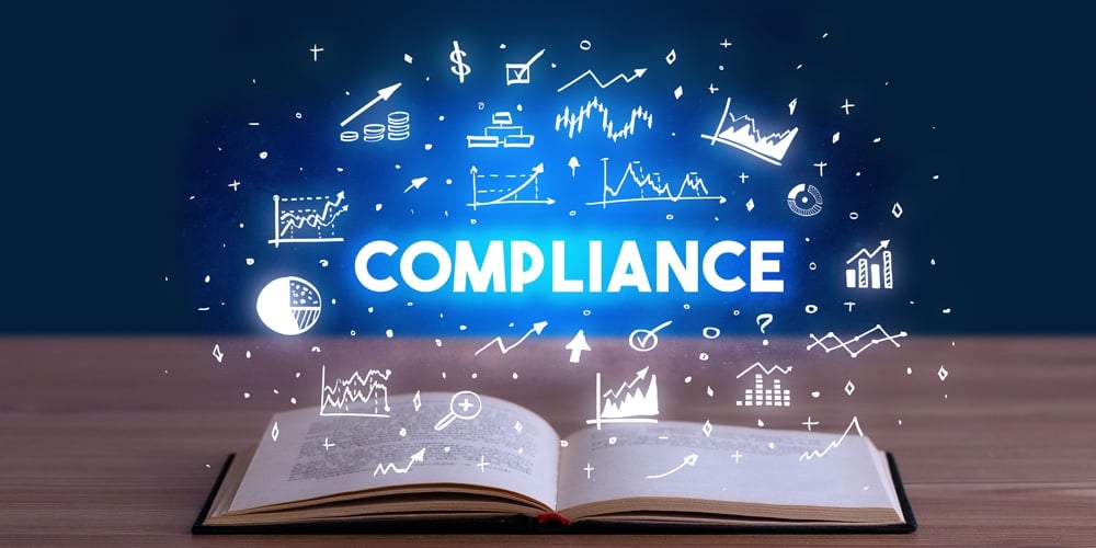 COMPLIANCE inscription coming out from an open book