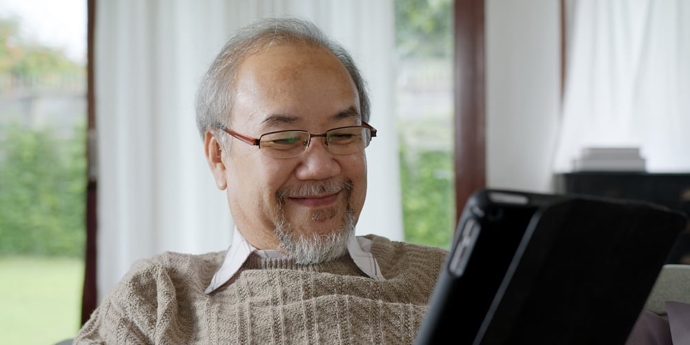 Candid Of Old Asian Retired Man Using Tablet Computer To Transfer Money Online Or Financial Payment