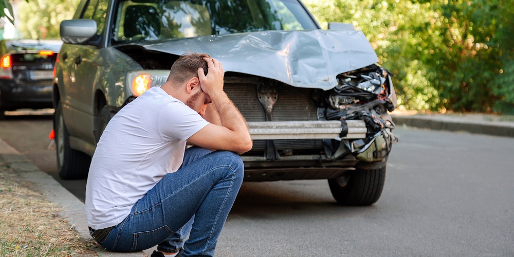 Picture1|Car Accident. Man Holding His Head After Car Accident. Man Regrets Damage Caused During Car Wreck. M