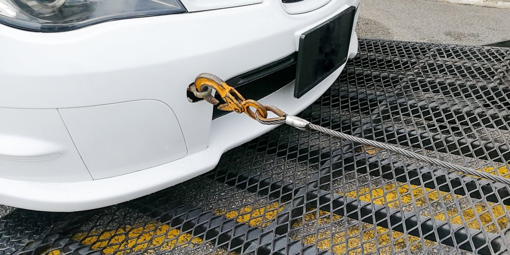 bigstock-Car-Towed-Onto-Flatbed-Tow-Tru-212245525