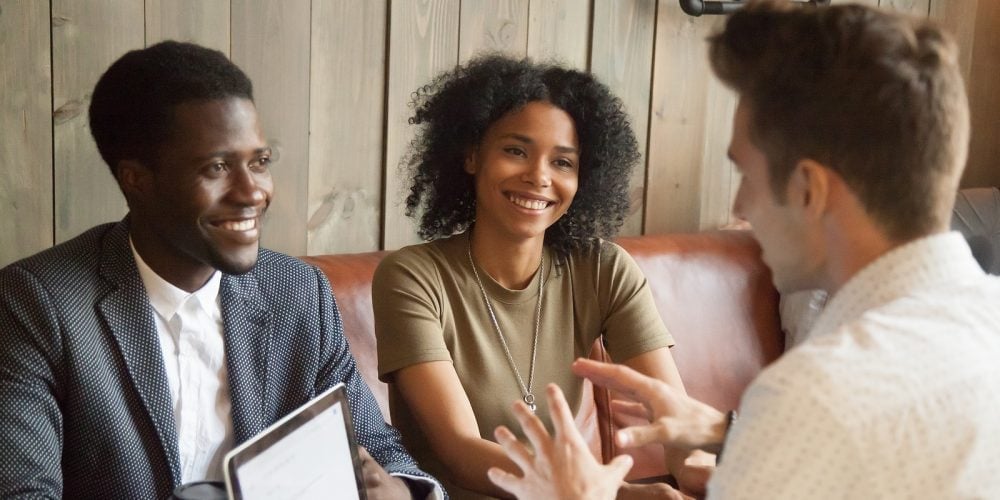 Caucasian Architect Talking To Smiling African American Couple